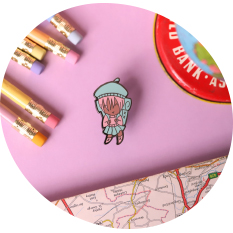 Colorful Photo of Enamel Pin of a Girl with a Backpack on a Pink Background for Etsy Listing