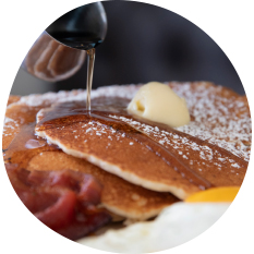 Syrup Pouring on Pancakes for Buttermilk Breakfast Eatery